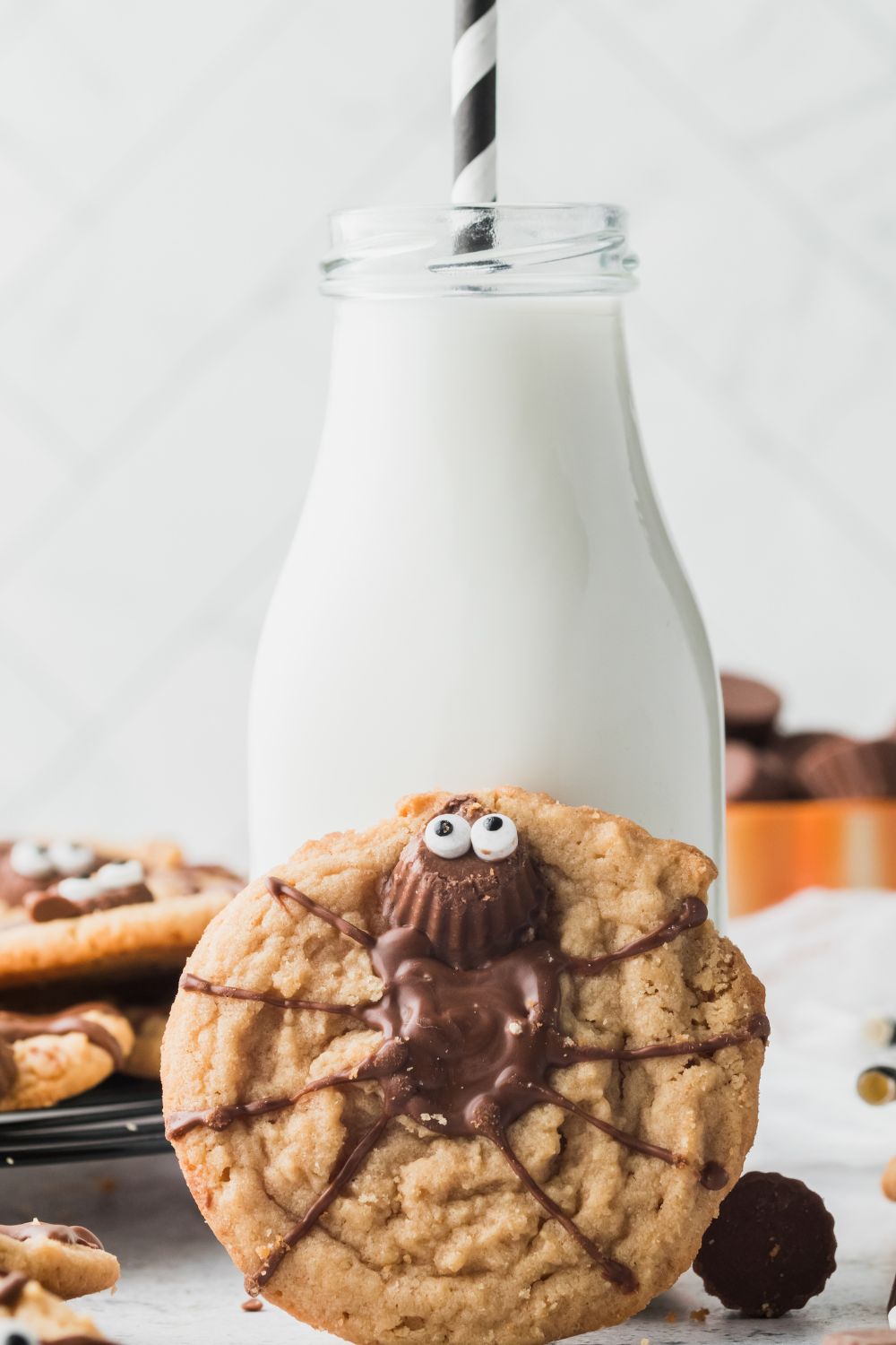cookie tilted up on milk jug on counter