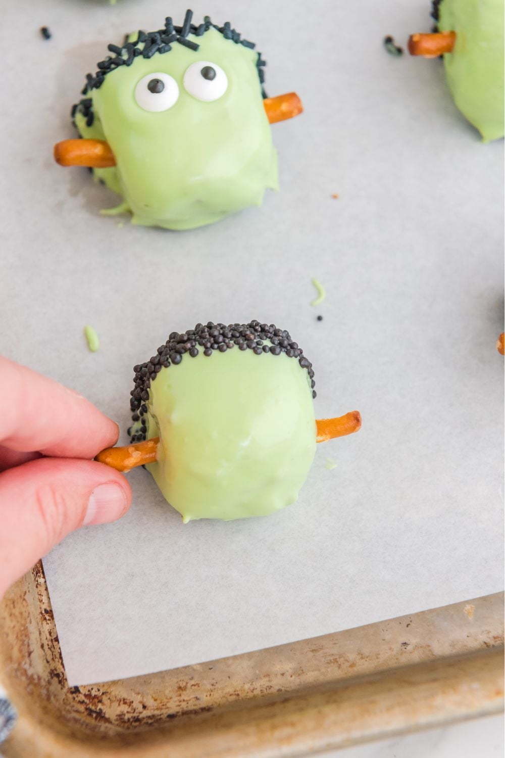 sticking pretzels into the sides of the truffles
