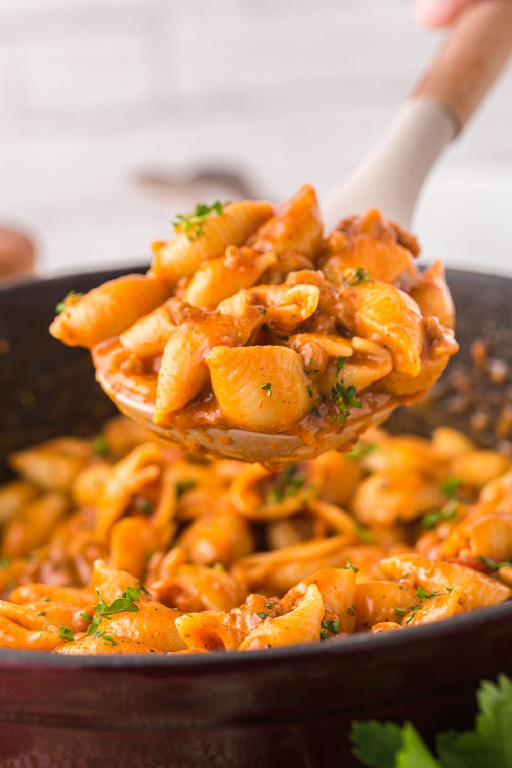 spoon of pasta over pan