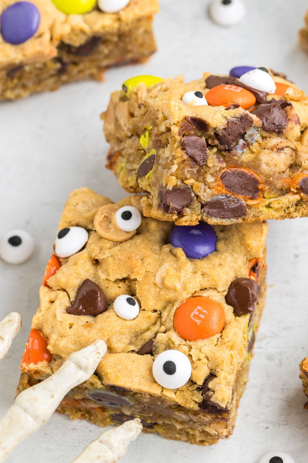 cookie bars on table with a skeleton halloween decoration by it