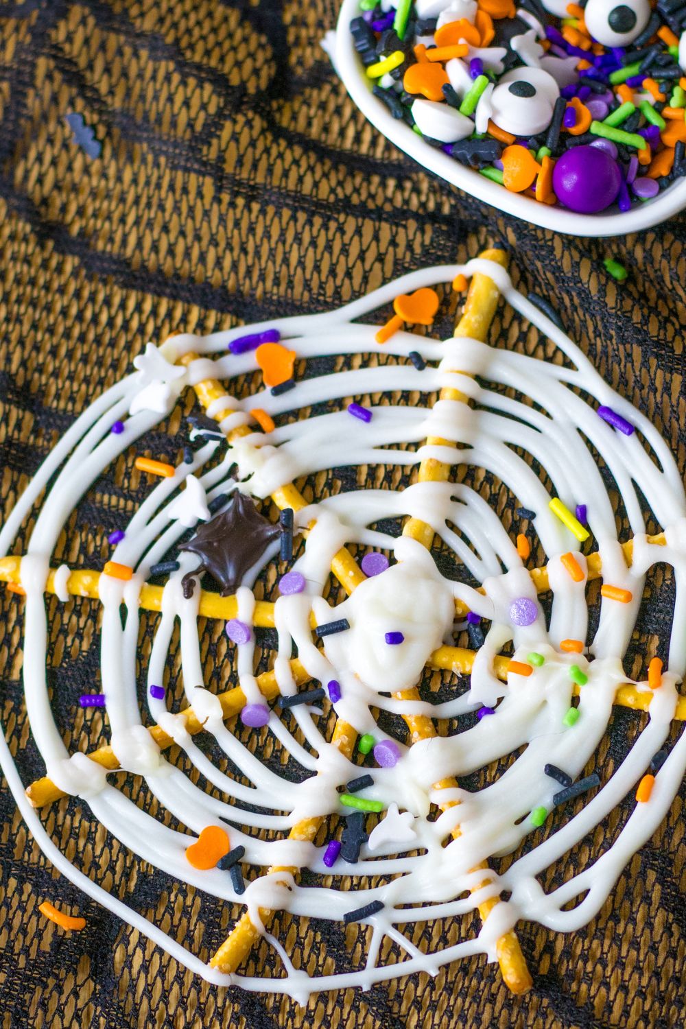 close up of pretzels on table with a container of sprinkles in background
