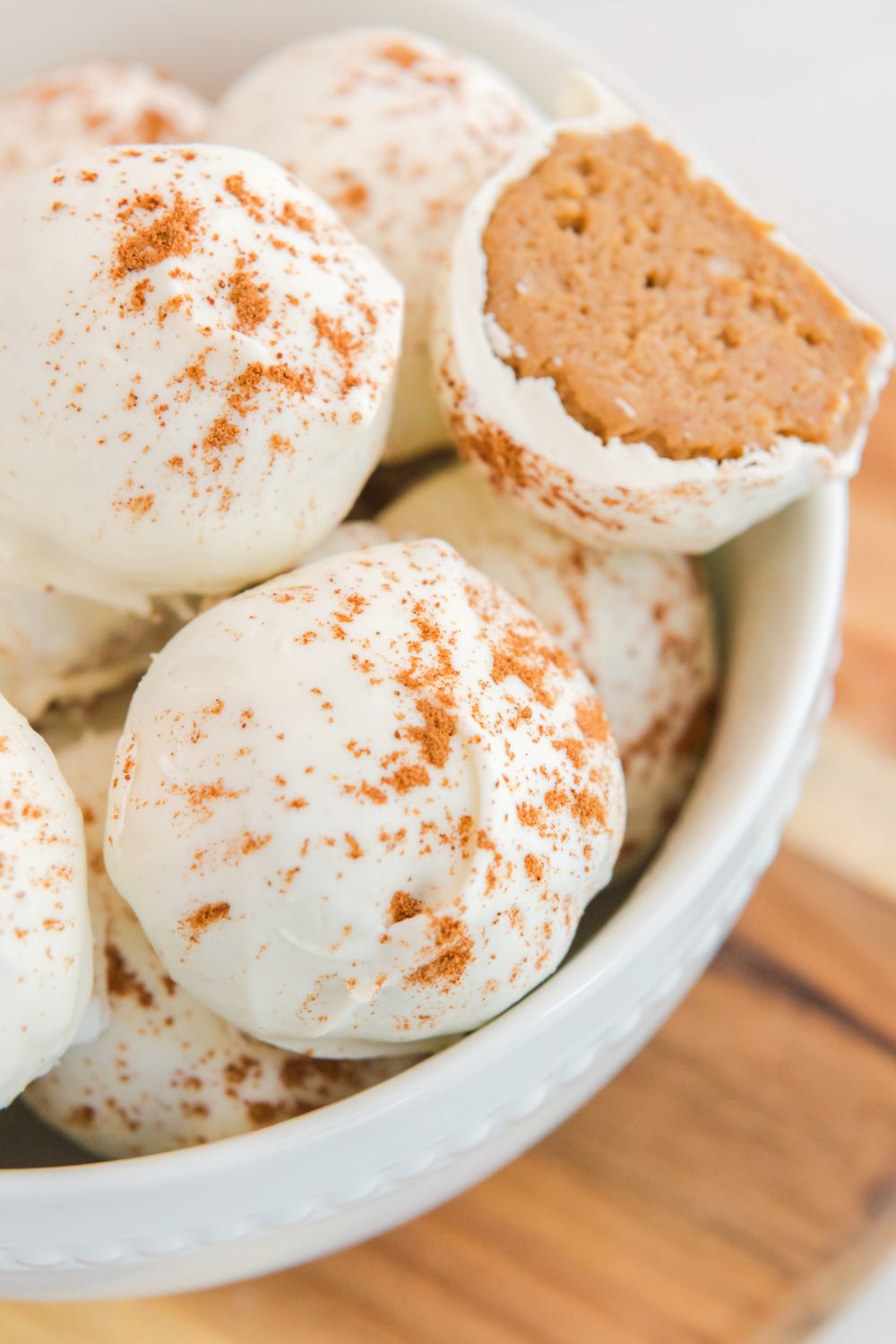 white chocolate pumpkin cheese cake bites in a white bowl on table