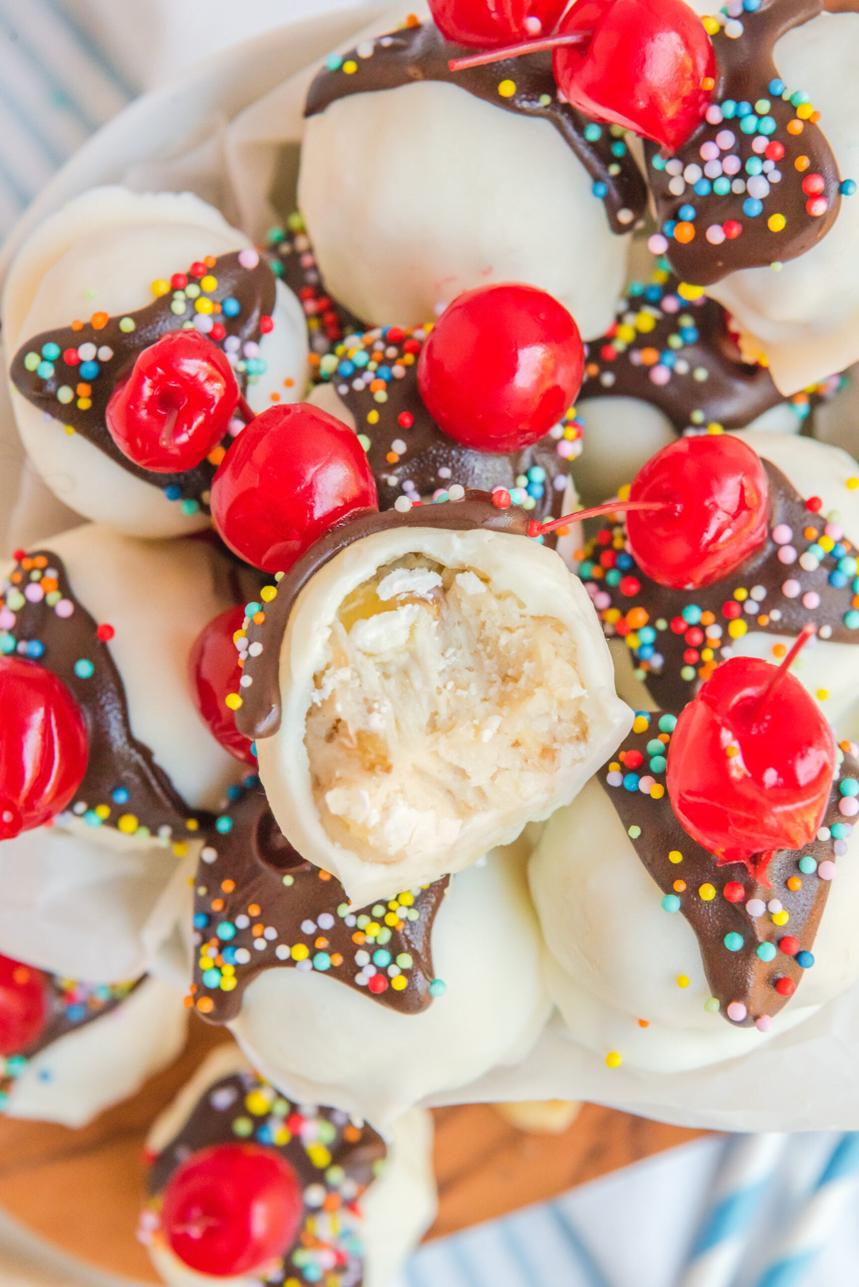 Overhead view of Banana Truffles stacked in a dish with a bit removed from the top truffle.