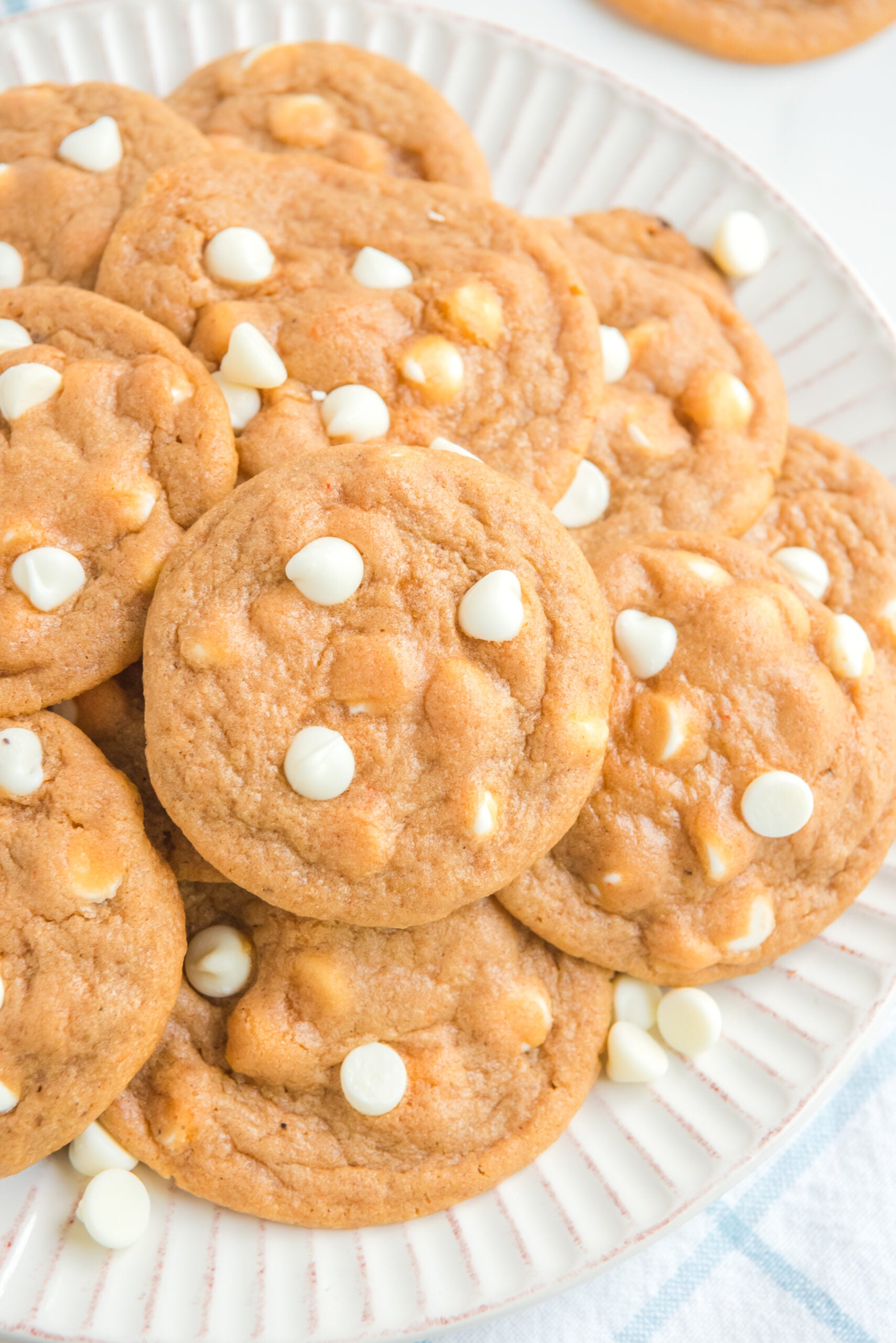 up close angle of a pile of Pumpkin Spice Pudding Cookies on a white plate