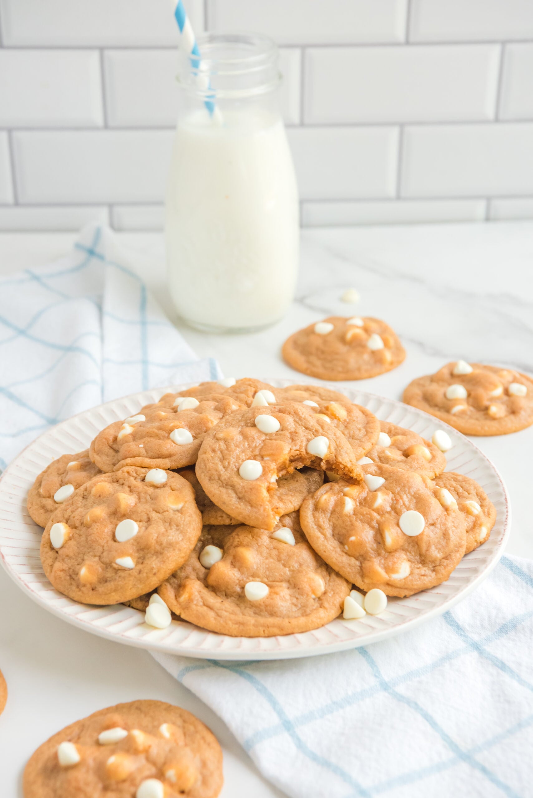 Pumpkin Spice Pudding Cookies on a white plate with the top cookie missing a bite
