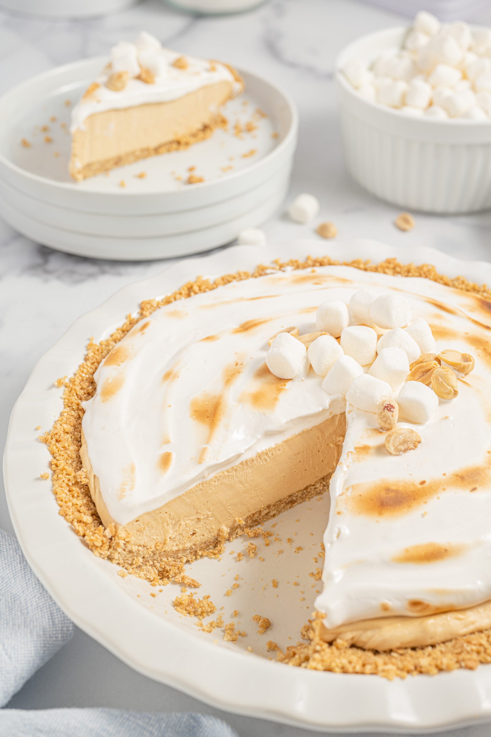 Fluffernutter Pie in a white baking dish with a slice removed