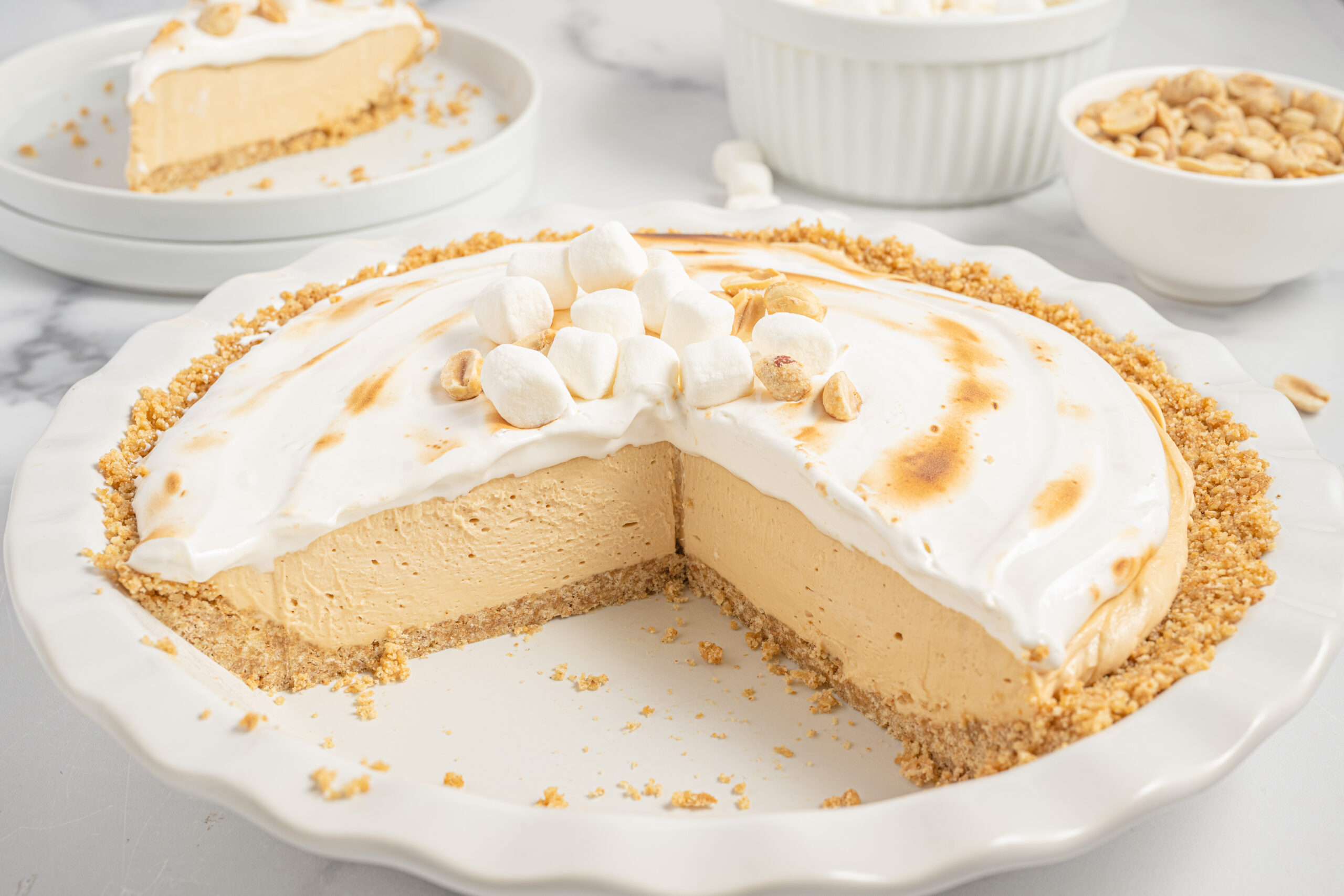 Fluffernutter Pie in a white baking dish with a couple slices missing