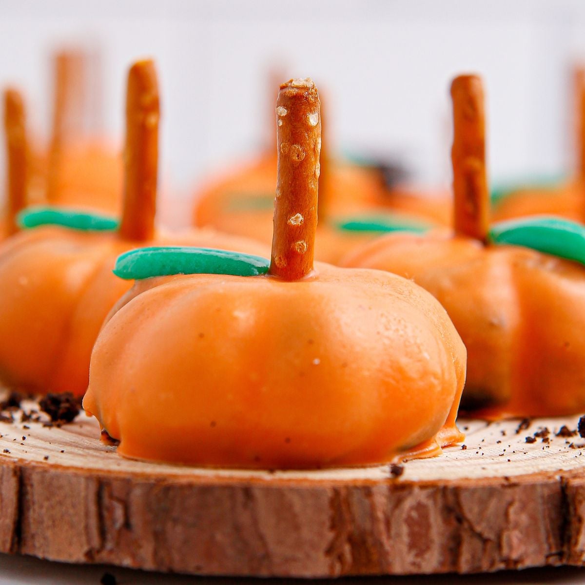 Pumpkin Oreo Balls on wooden tray