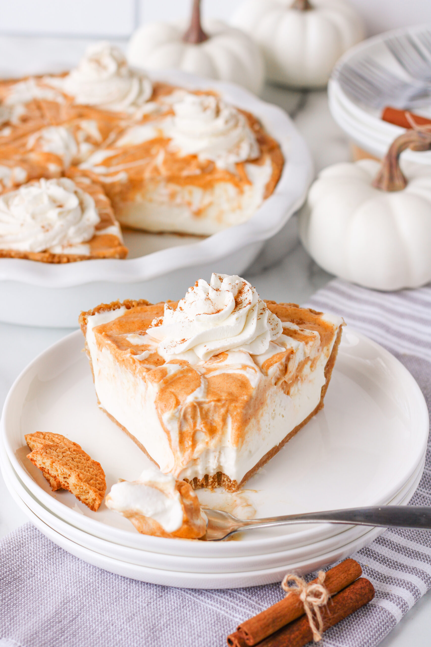 Pumpkin Ice Cream Pie slice on a white plate with a bite missing