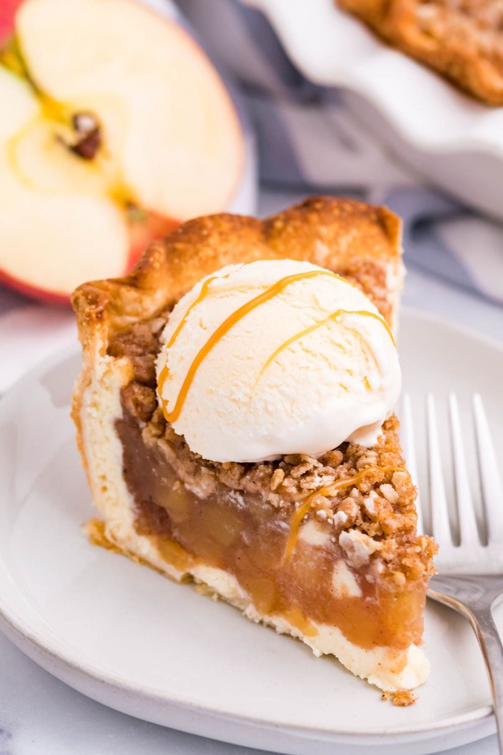 apple crisp cheesecake with ice cream with a drizzle of caramel sauce