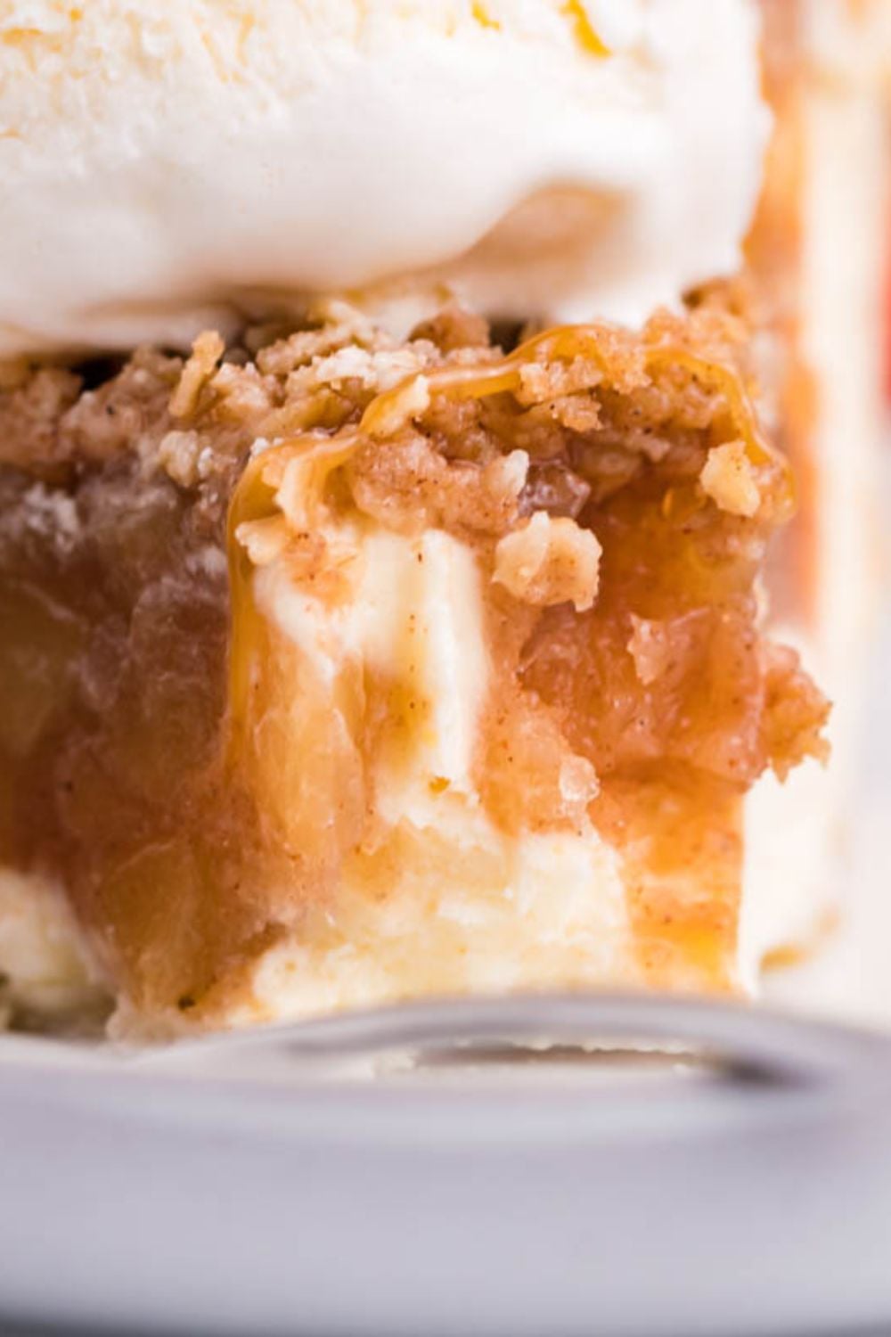apple crisp cheesecake on plate with bite taken out