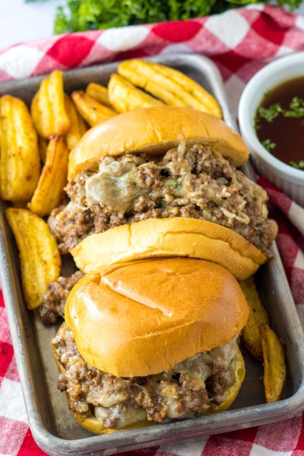 au jus sandwich on a metal tray