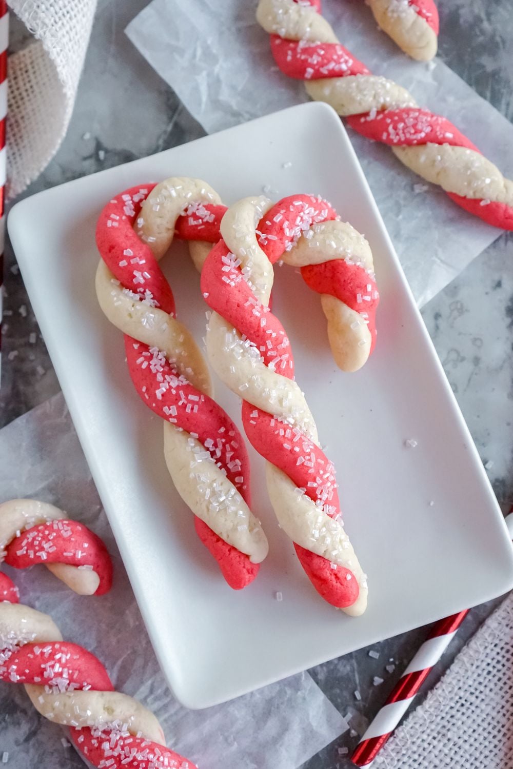 Christmas cookies on plate with straw beside it for a pop of color
