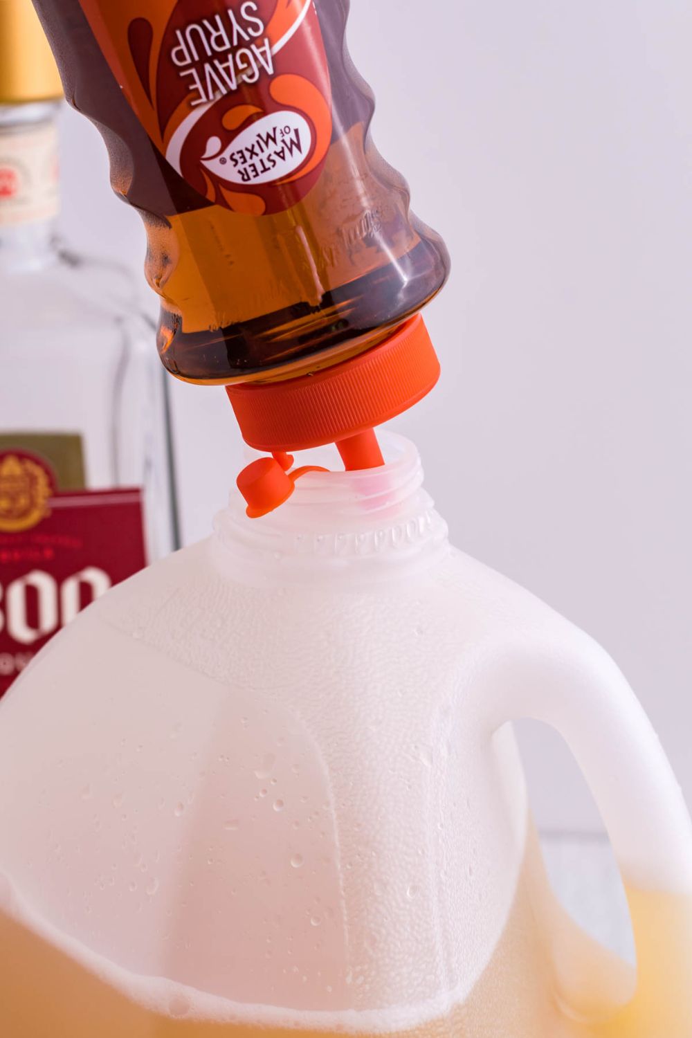 simpl syrup pouring into a milk jug