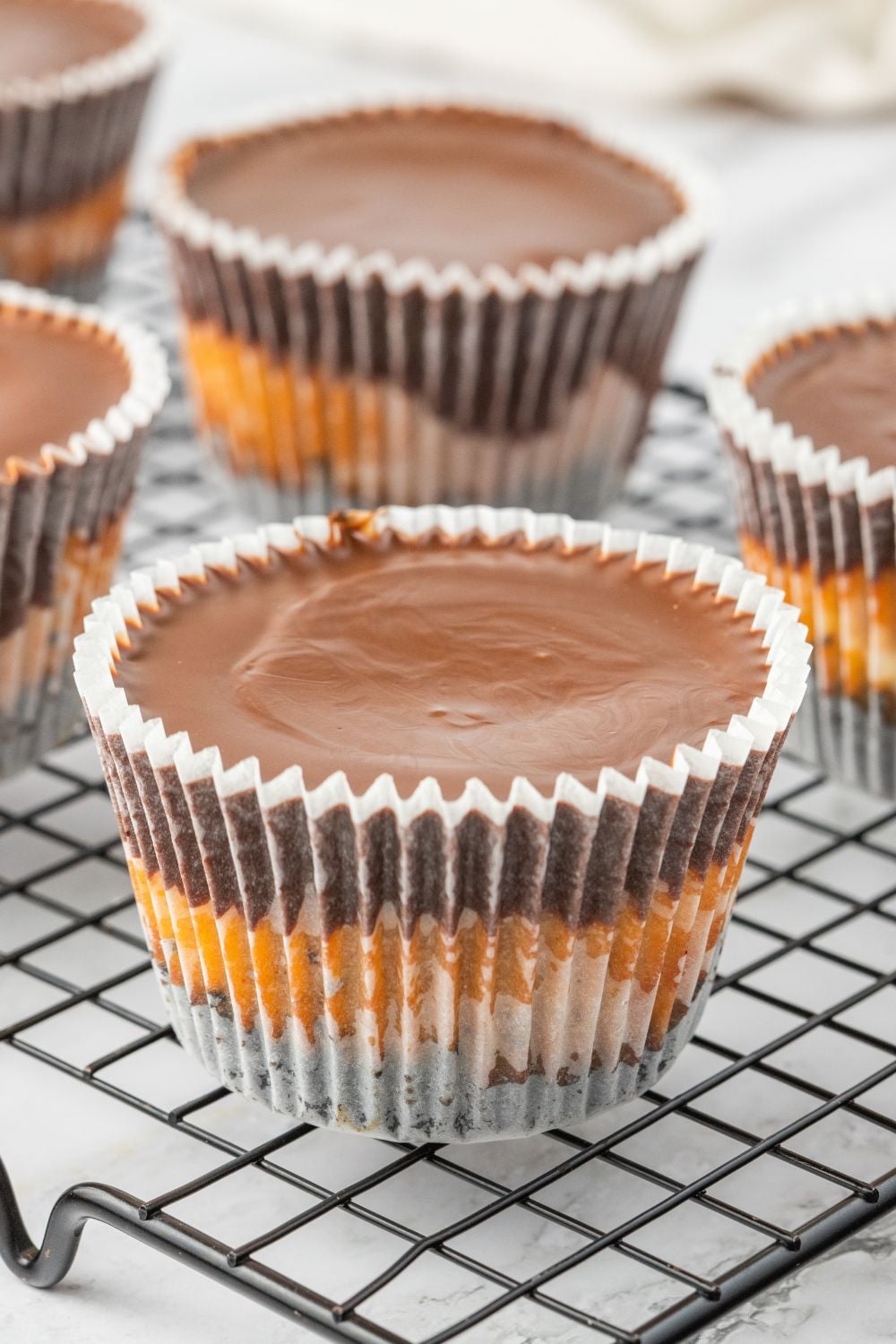 peanut butter cheesecake cups on wire rack