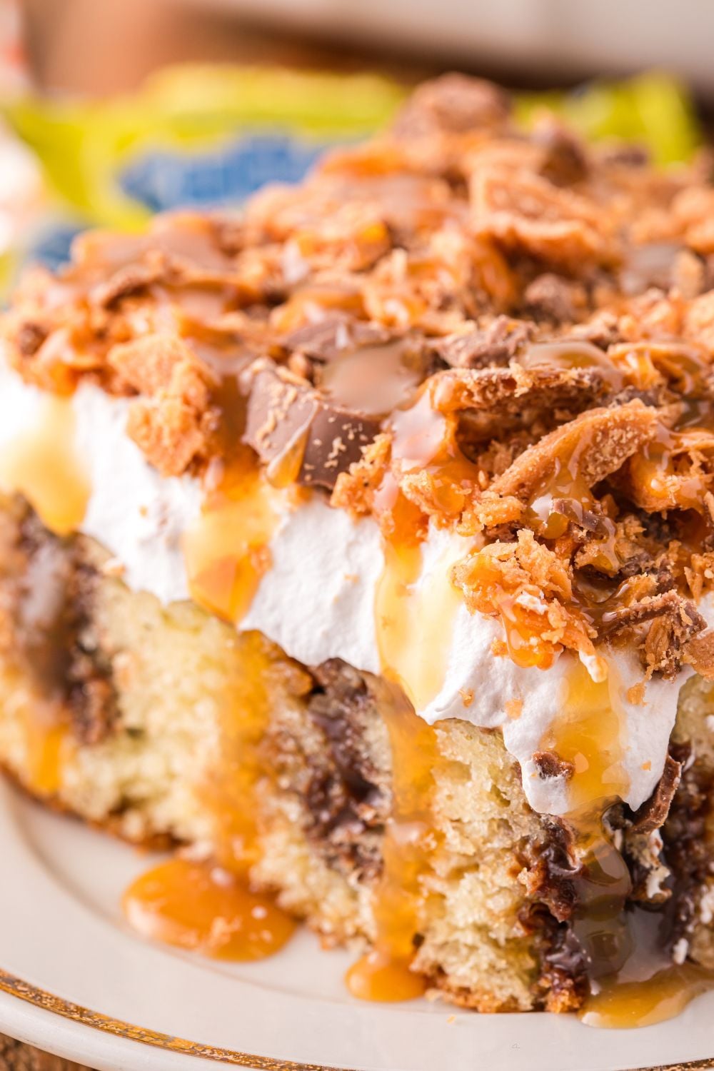 plate with a slice of cake topped with butterfinger pieces