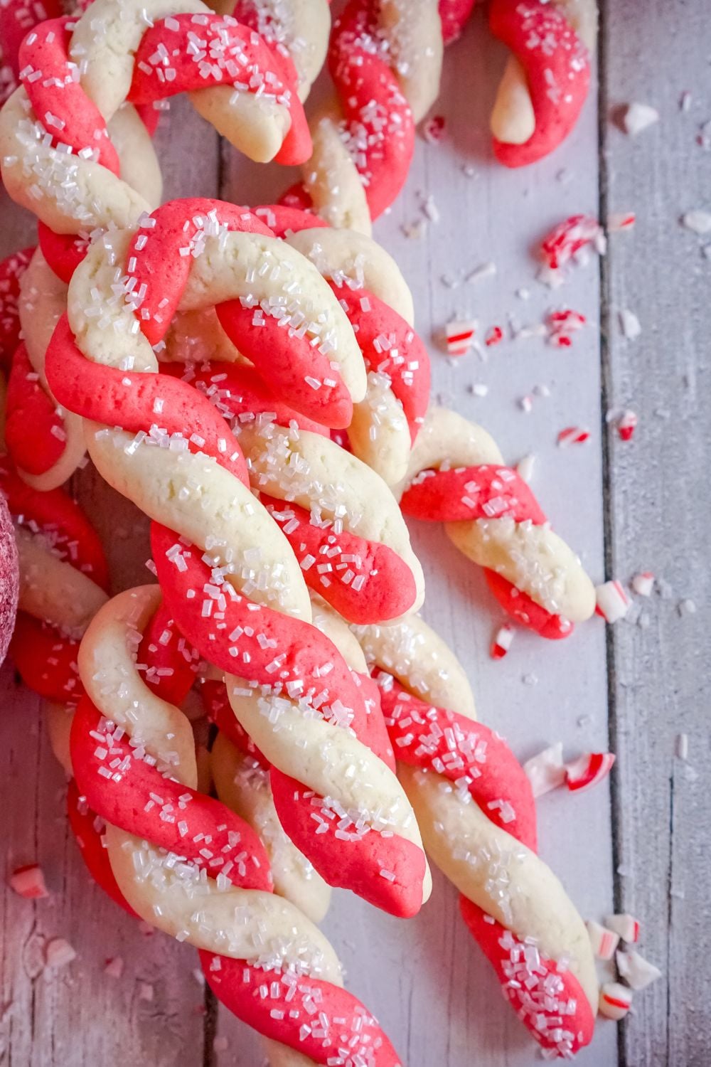 candy cane cookies stacked on a tray on table