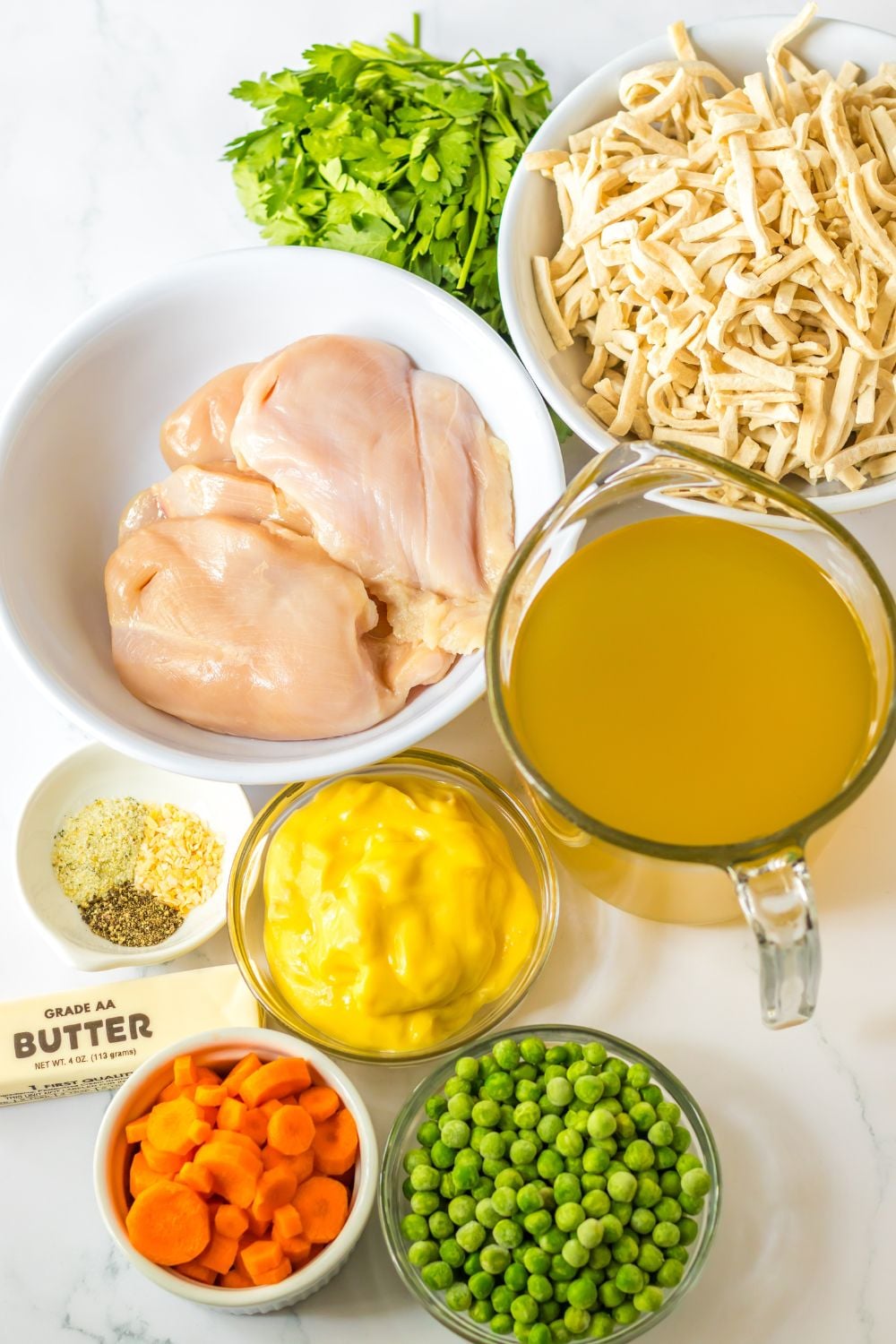 ingredients for chicken noodle soup on table