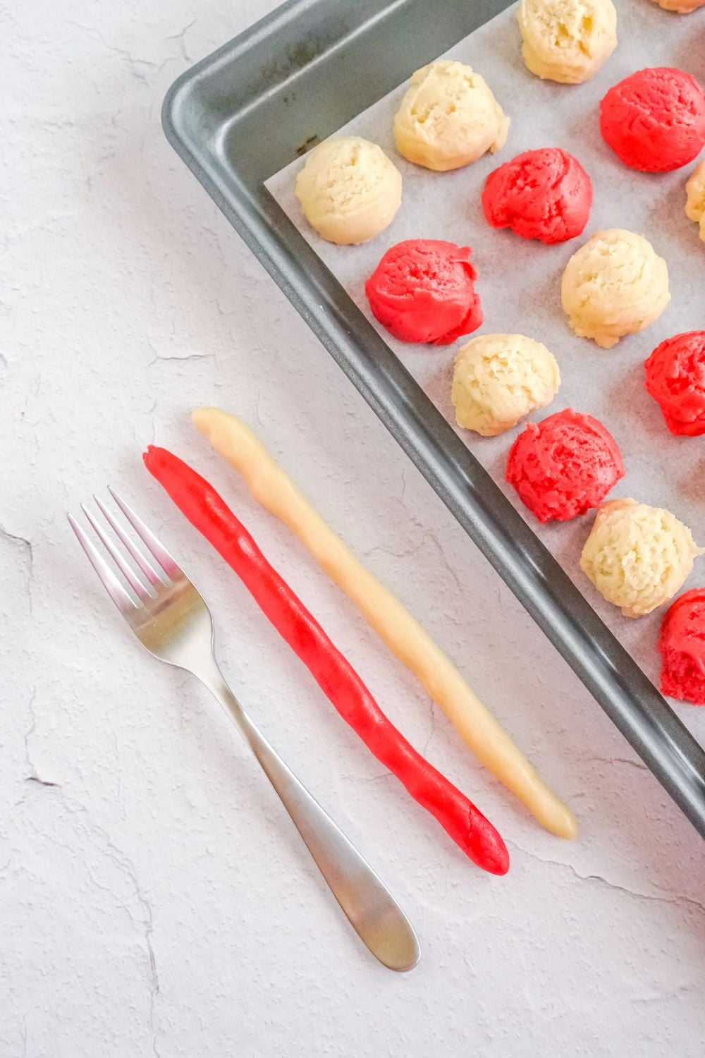 strings of cookie dough sitting by a fork