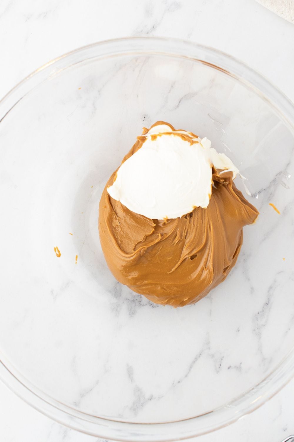 cookie butter and cream cheese in a glass bowl
