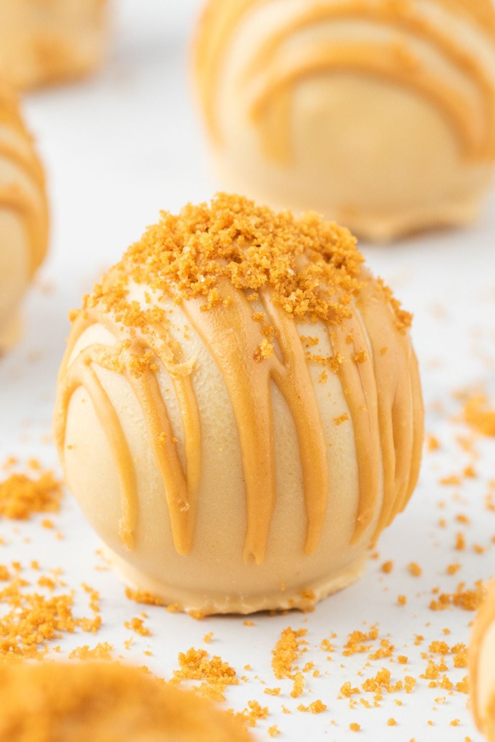 cookie butter truffles on table with crumbs around it