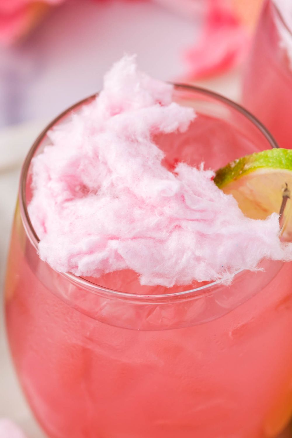 close up of a cotton candy drink with cotton candy sitting on top