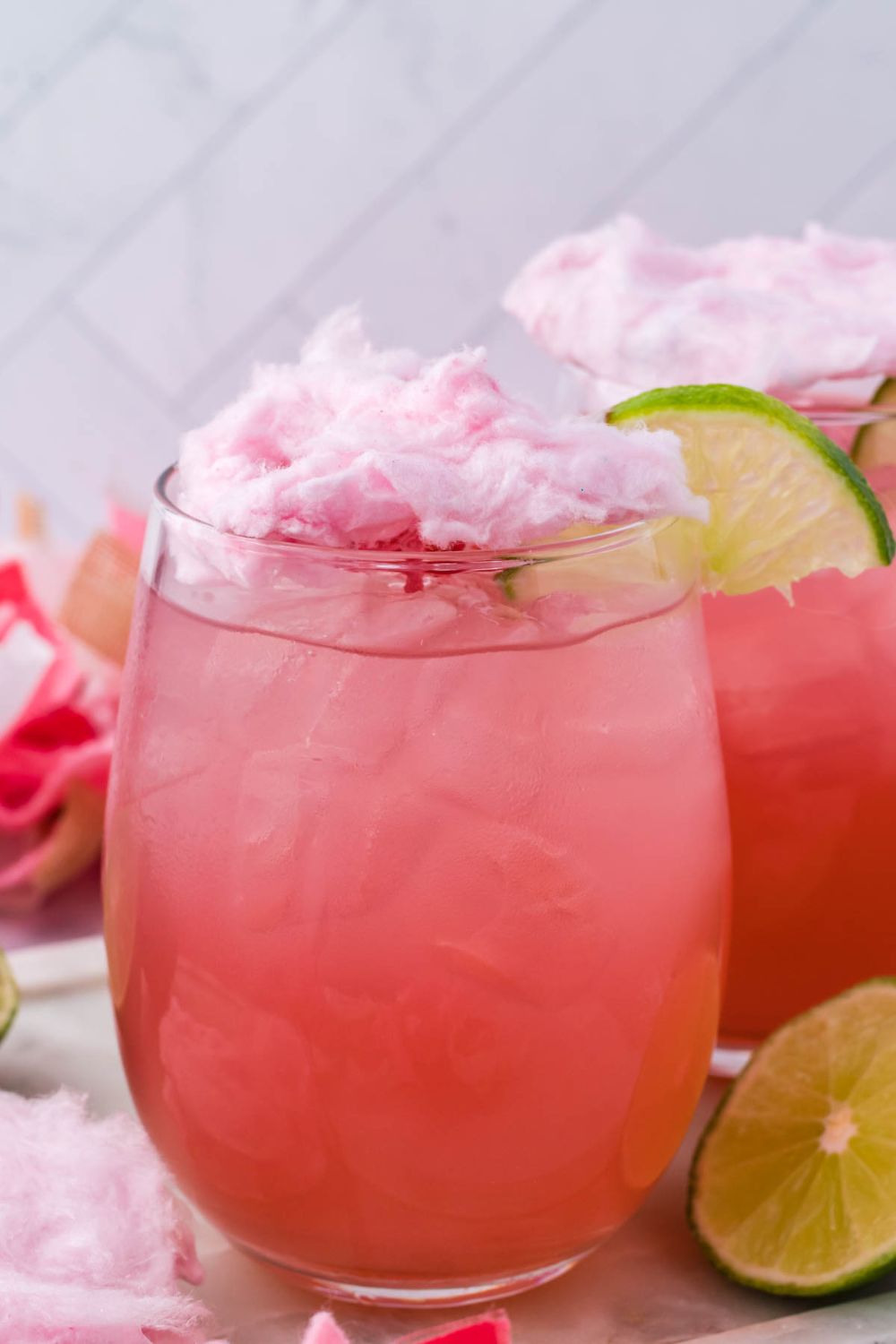 cotton candy martini on table with garnishments on it