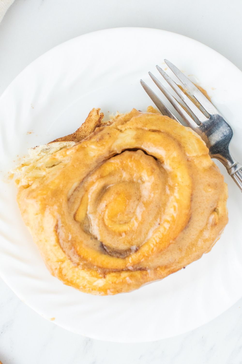 overhead shot of cinnamon roll on plate on table