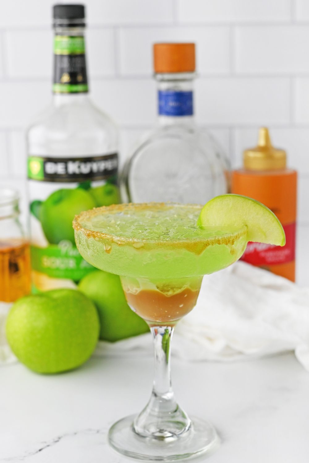 fall margarita on table with ingredients behind it on table