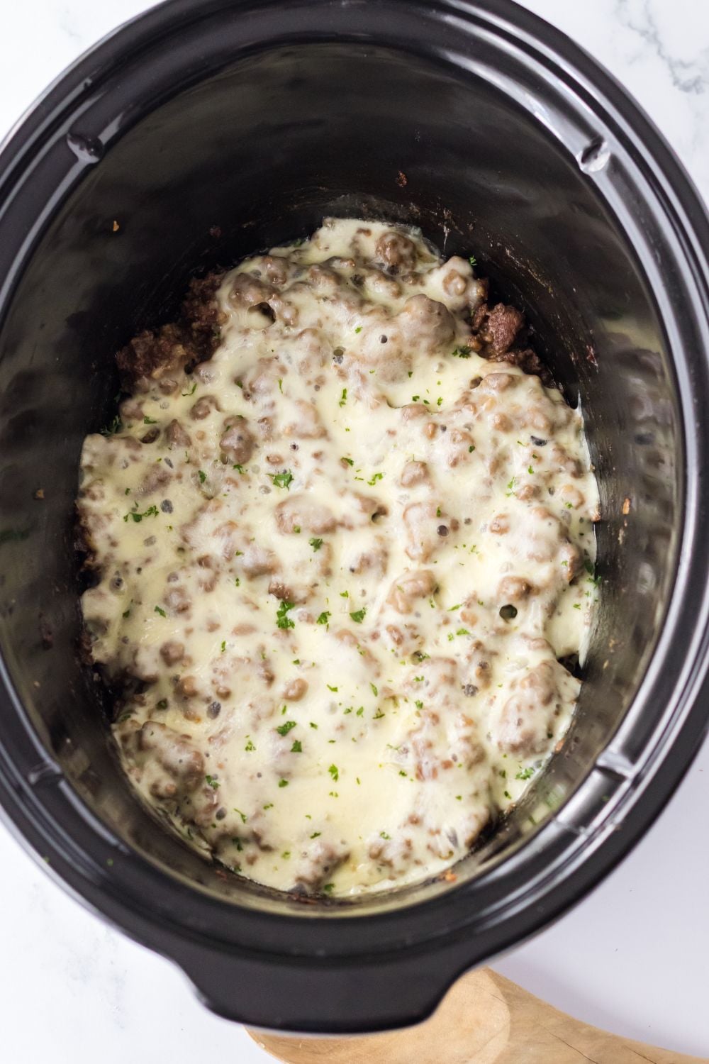 cheese melted on top of meat mixture in slow cooker 