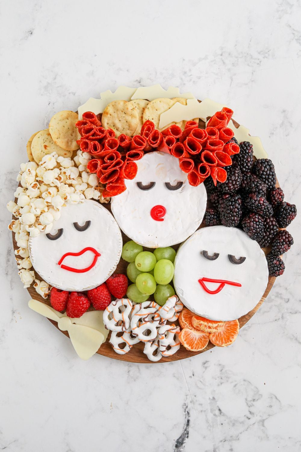 charcuterie board with Sanderson sisters made out of brie cheese 