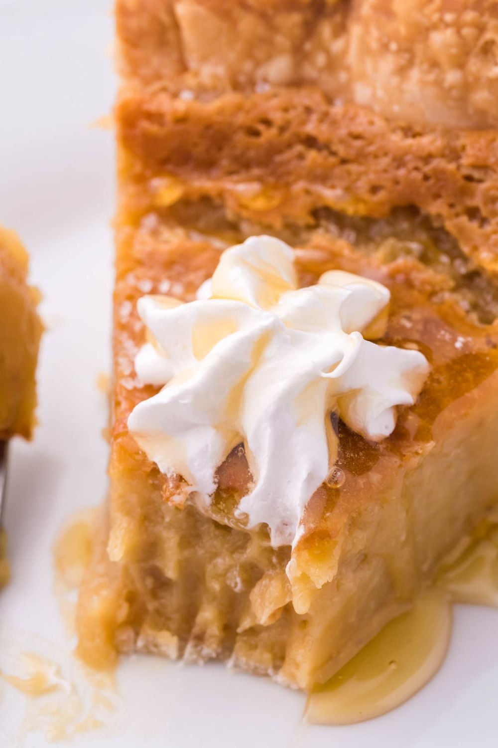 honey pie on plate with whipped cream and honey drizzled on top