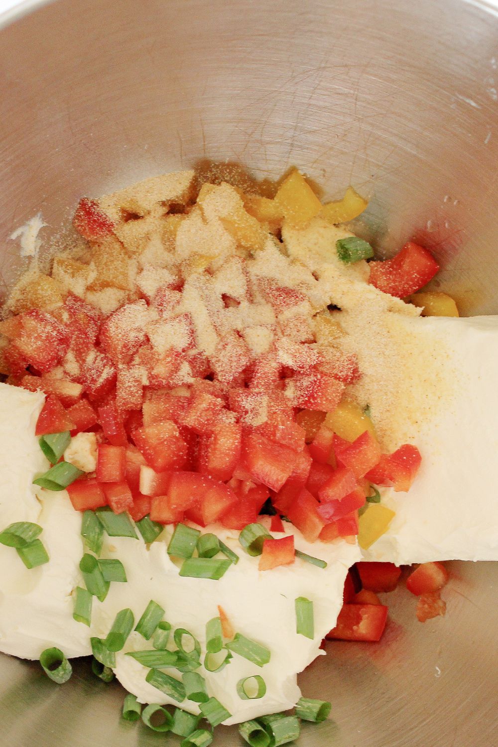 cream cheese mixture in a bowl with peppers, onions, ranch seasoning