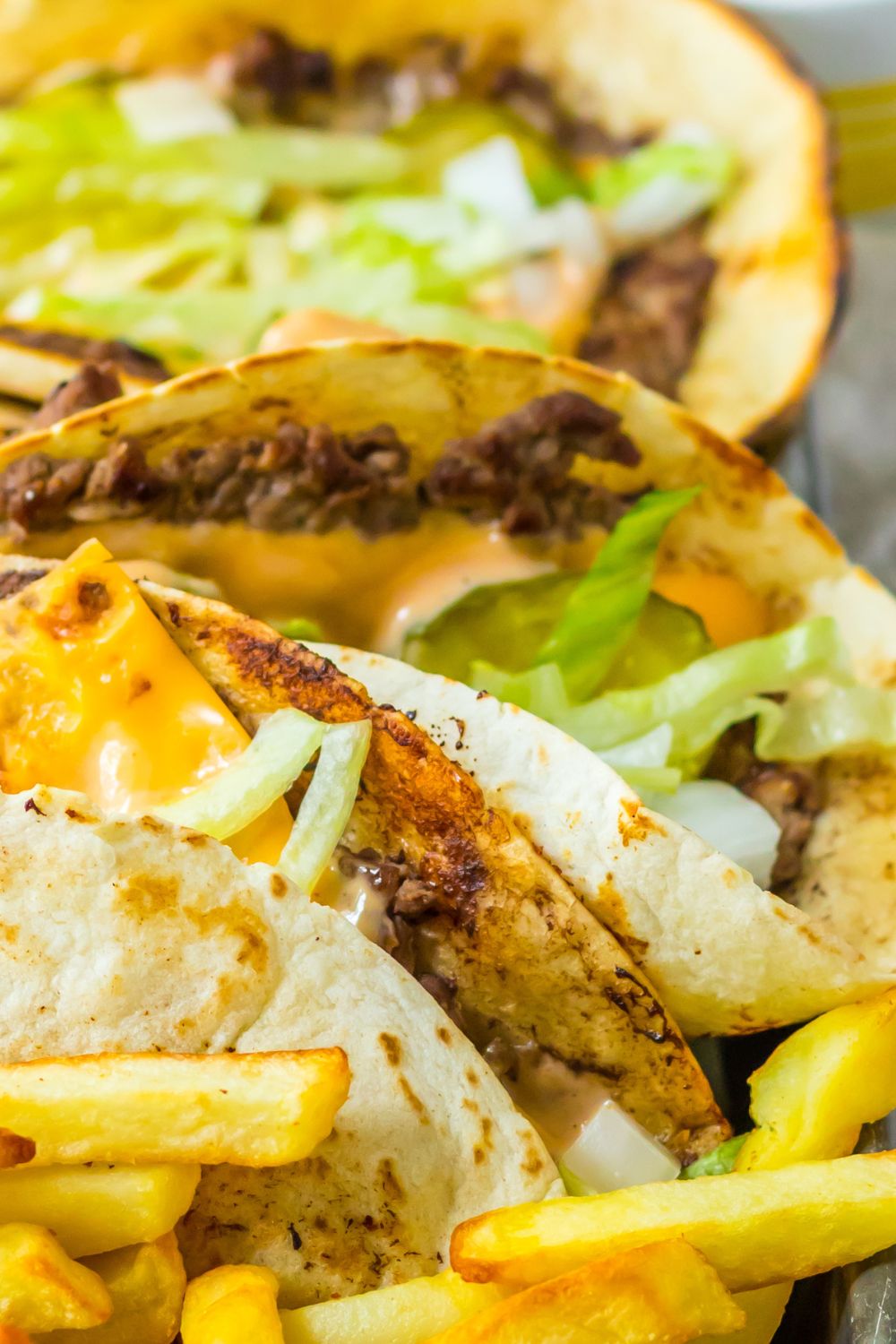 platter with Big Mac tacos and french fries on a metal tray
