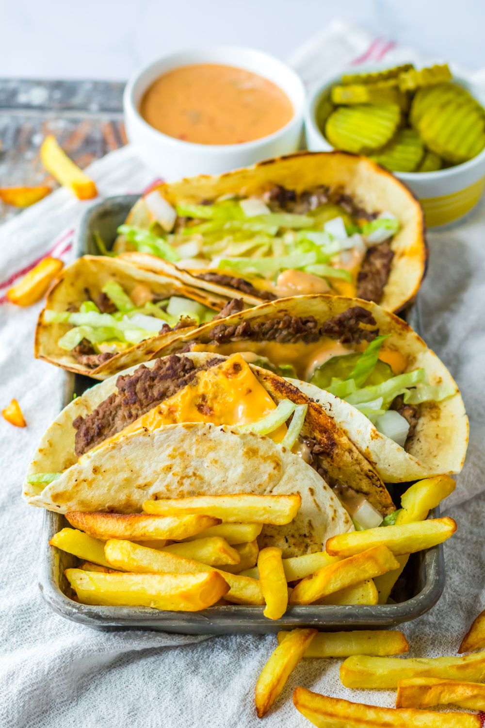 plate with big mac smash tacos and fries around it