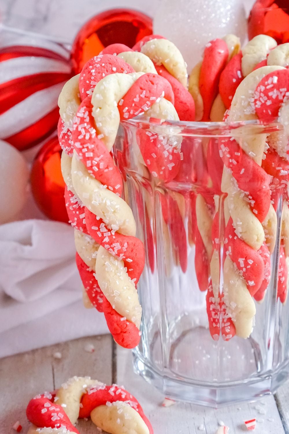 glass with candy cane cookies hanging on it