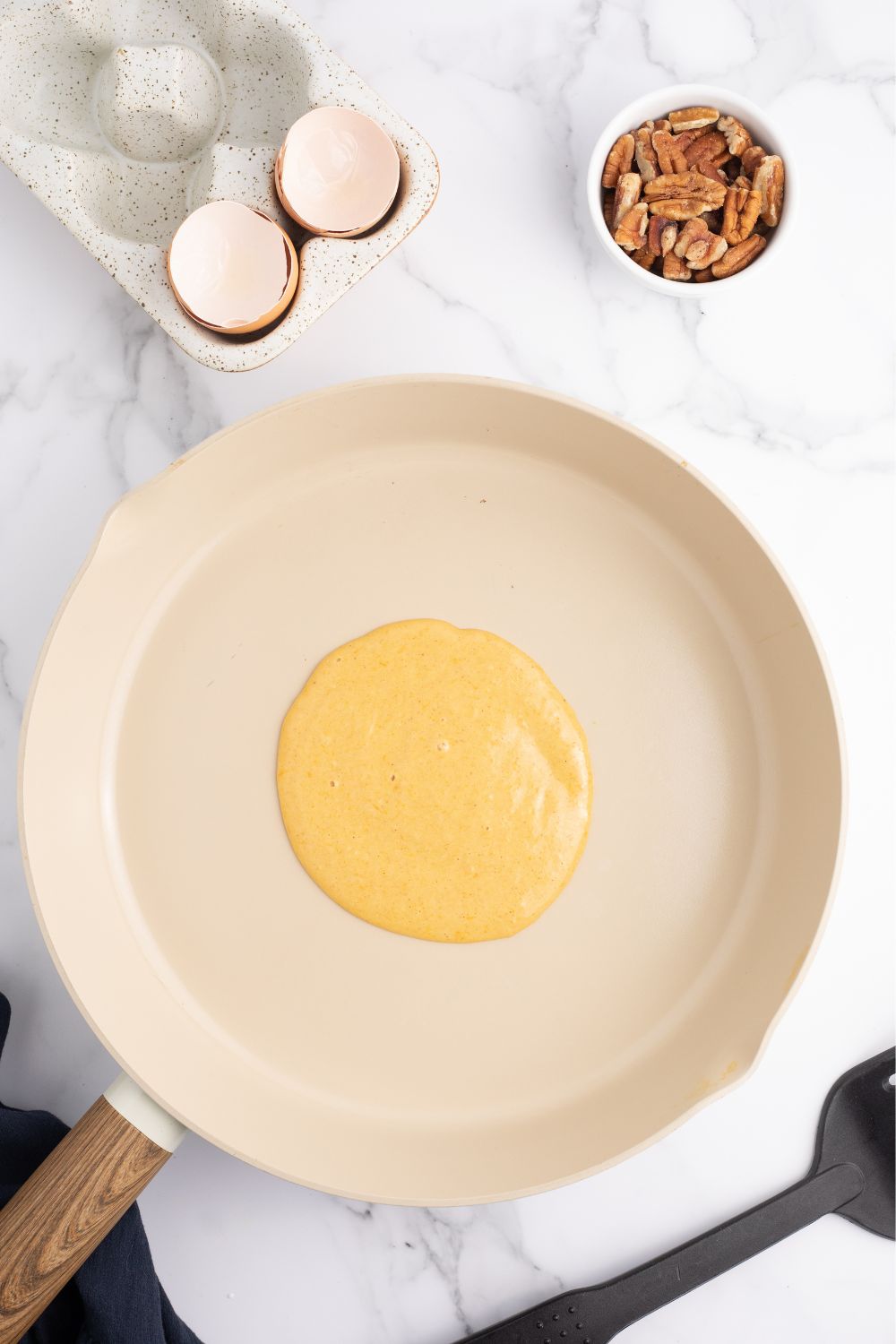 raw pancake batter in a skillet 