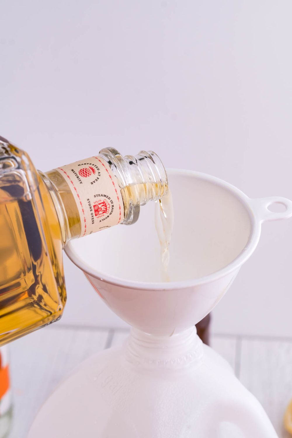 tequila pouring into a funnel
