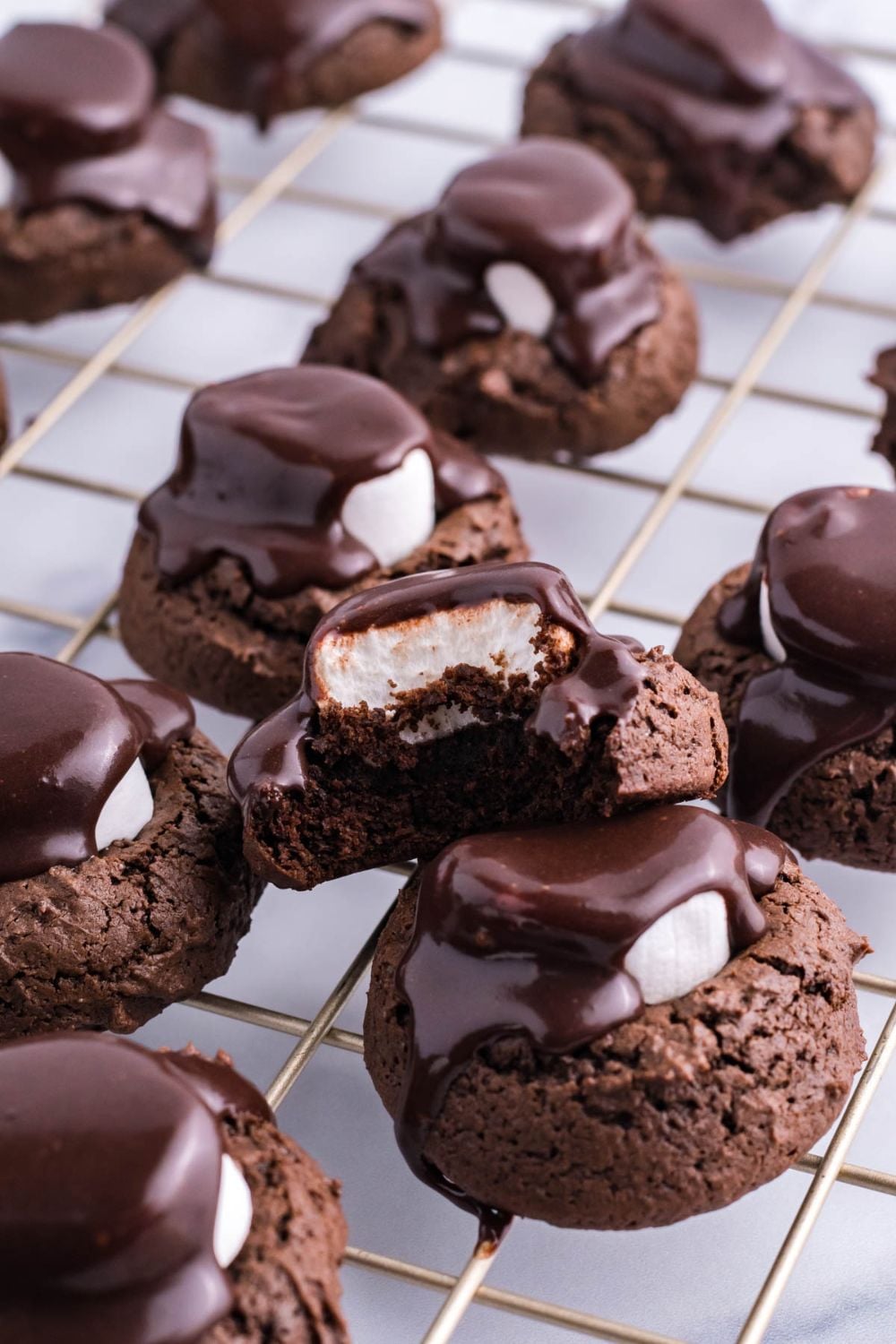 marshmallow choclate cookies sitting on cooling rack on top of each other
