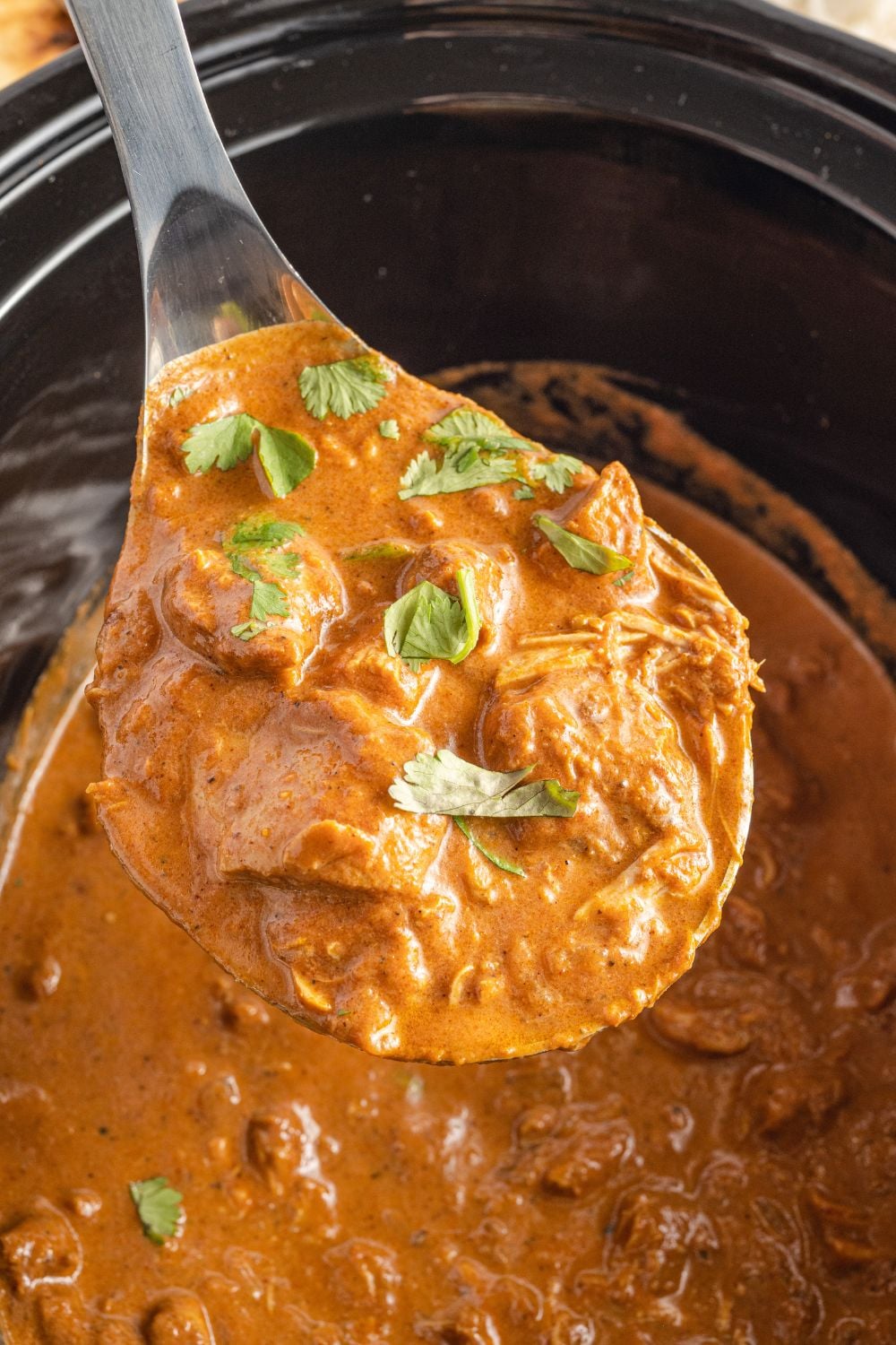 masala in a ladle above slow cooker