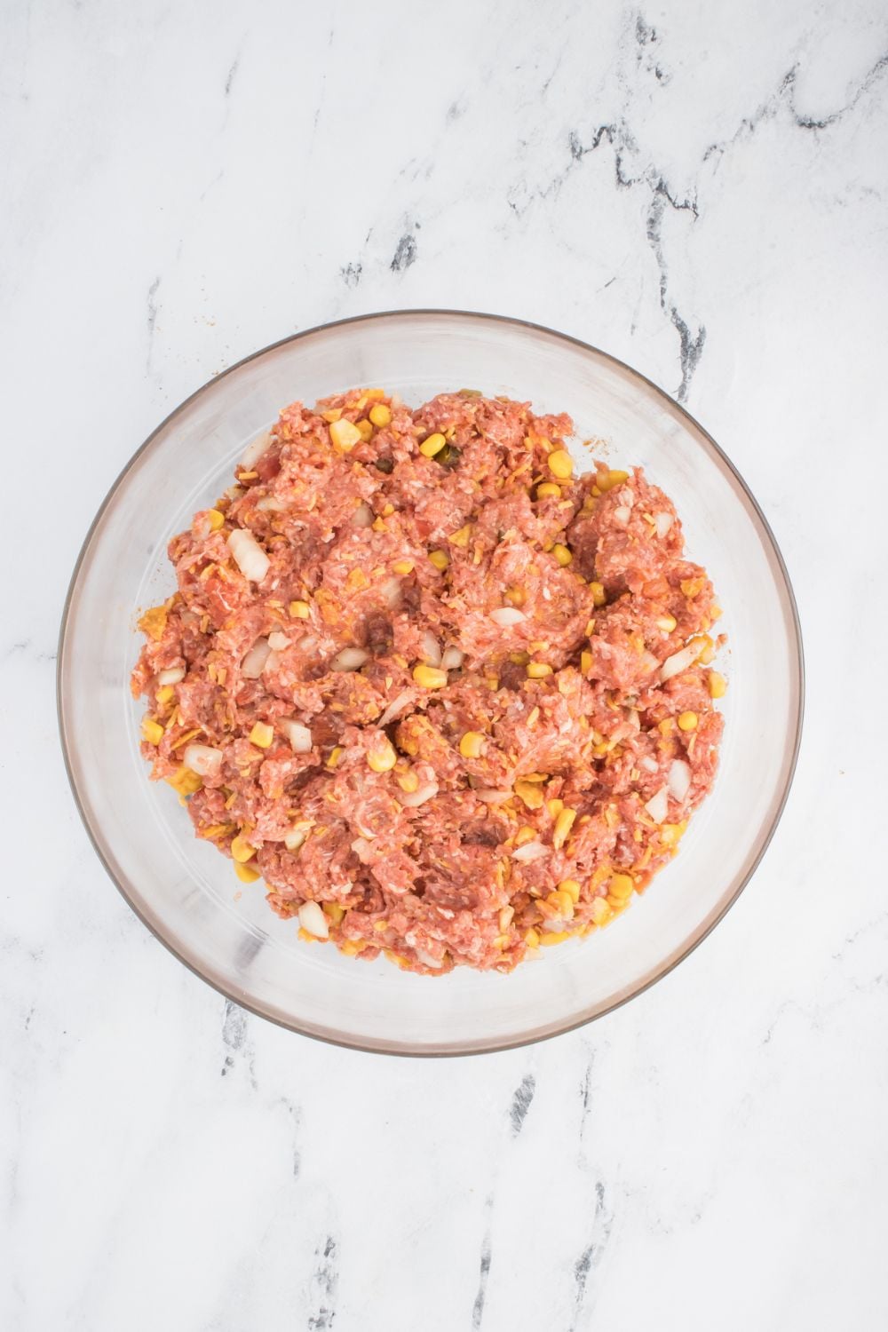 raw meatloaf mixture in a glass bowl on table