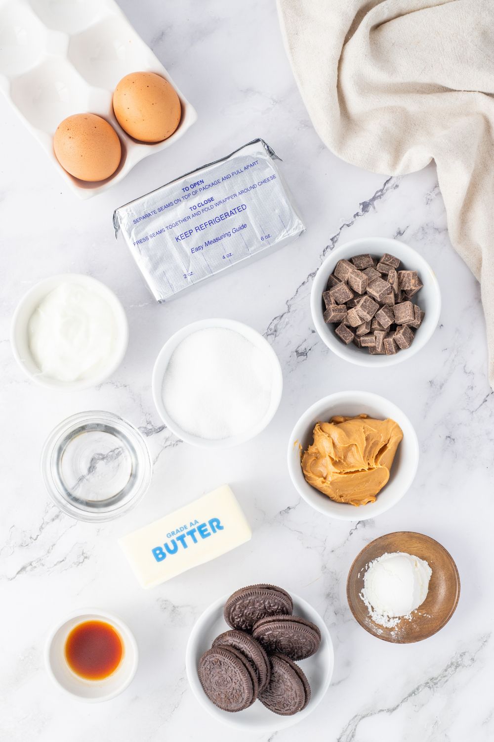 peanut butter cheesecake ingredients on a marble countertop