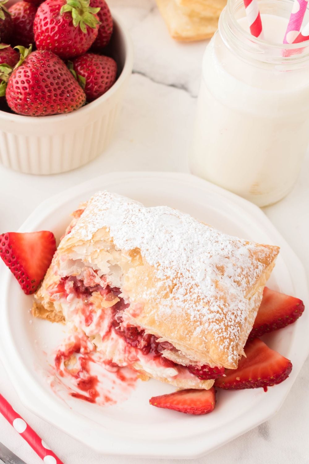 puff pastry strawberry puff with bite taken out of it