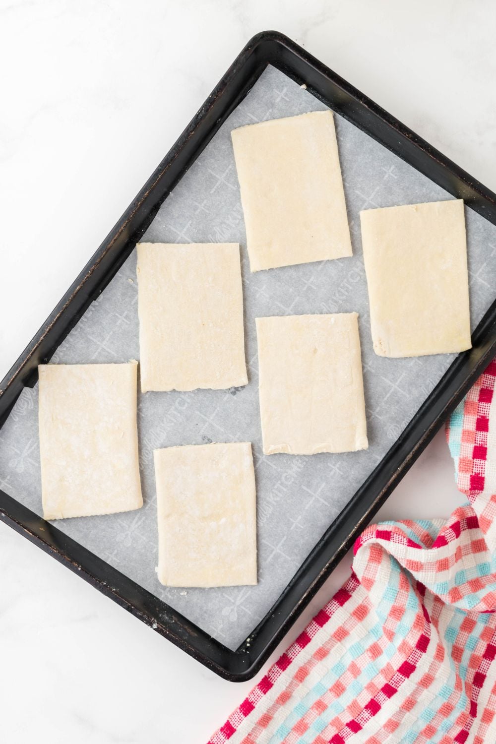sliced puff pastry cut into rectangles in pan