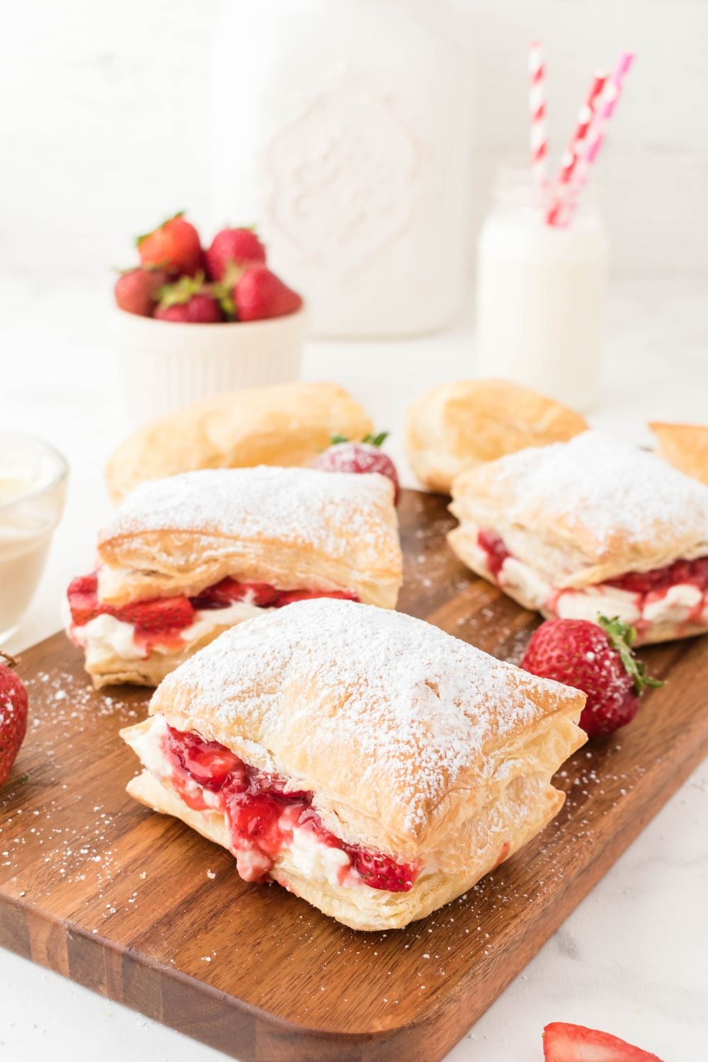 puff strawberry dessert on wooden cutting board