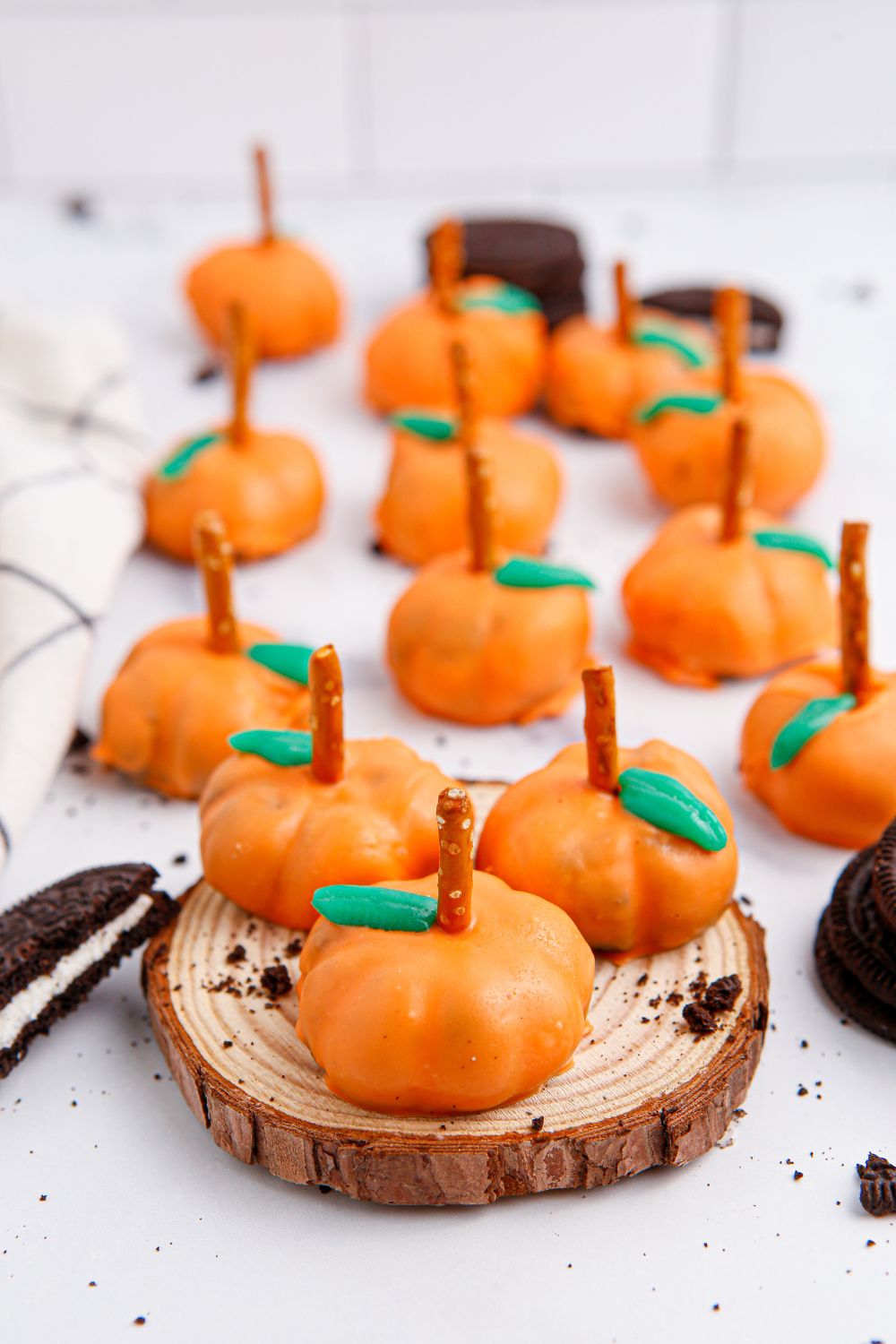 pumpkin balls all over counter with cookies scattered around them