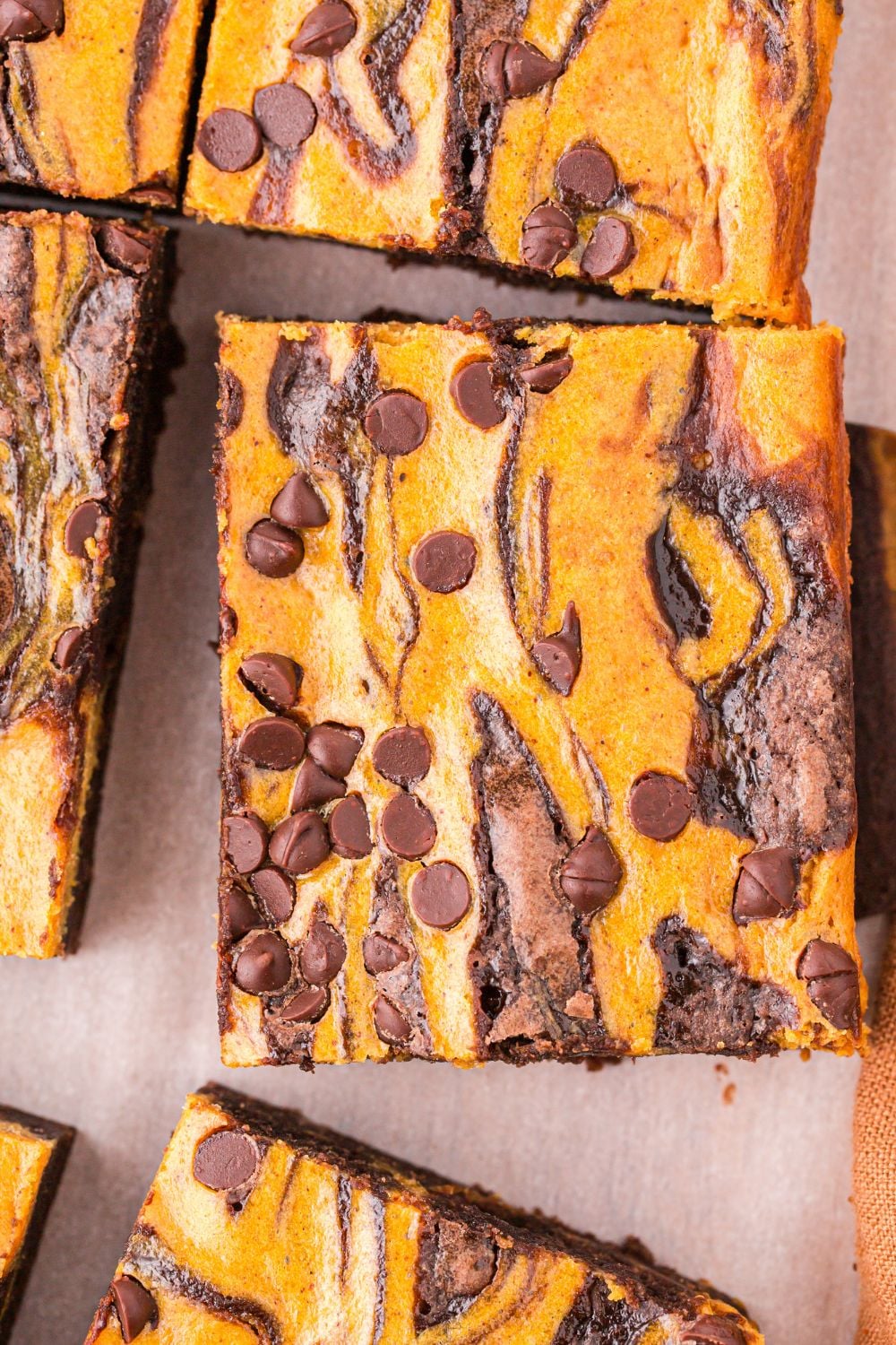 pumpkin brownie on parchment paper lined table