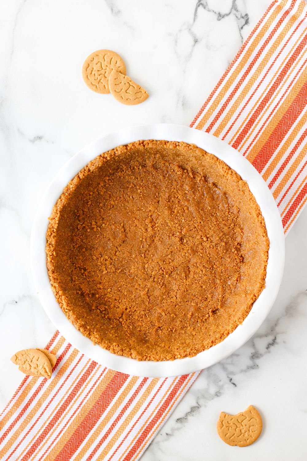 gingersnap crust in a pan on table