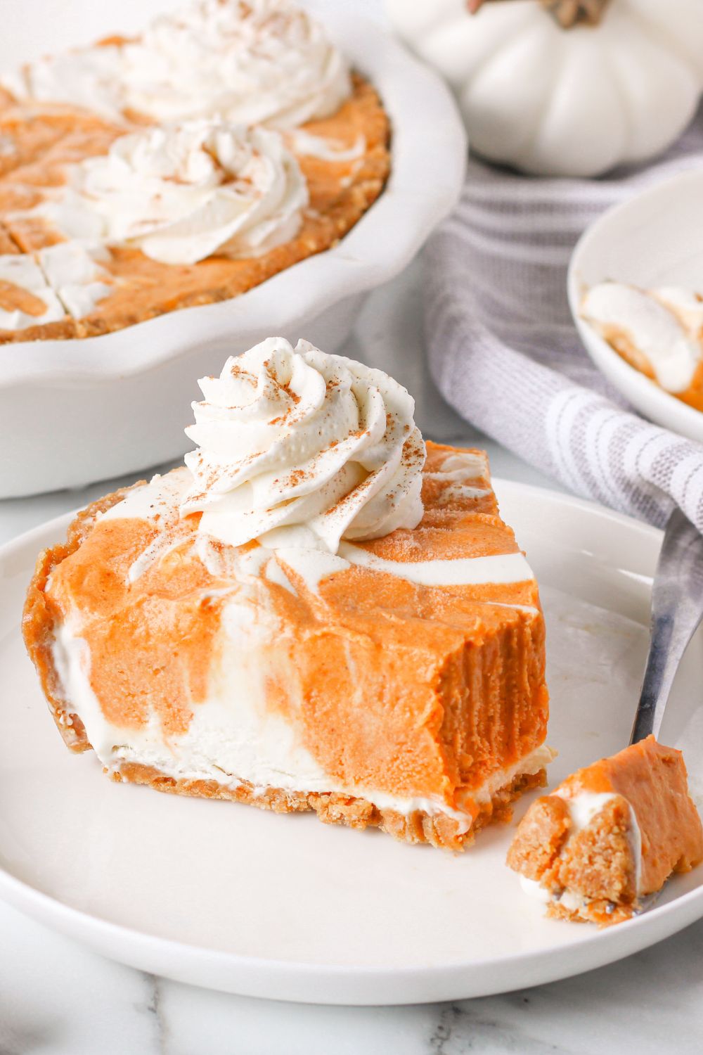 slice of pumpkin ice cream pie on plate with bite taken out of it