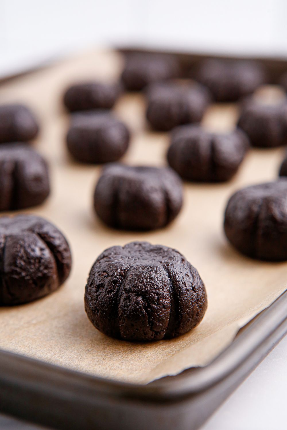 Oreo ball with lines to mimic a pumpkin